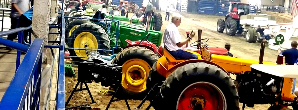 Long row of antique tractors.